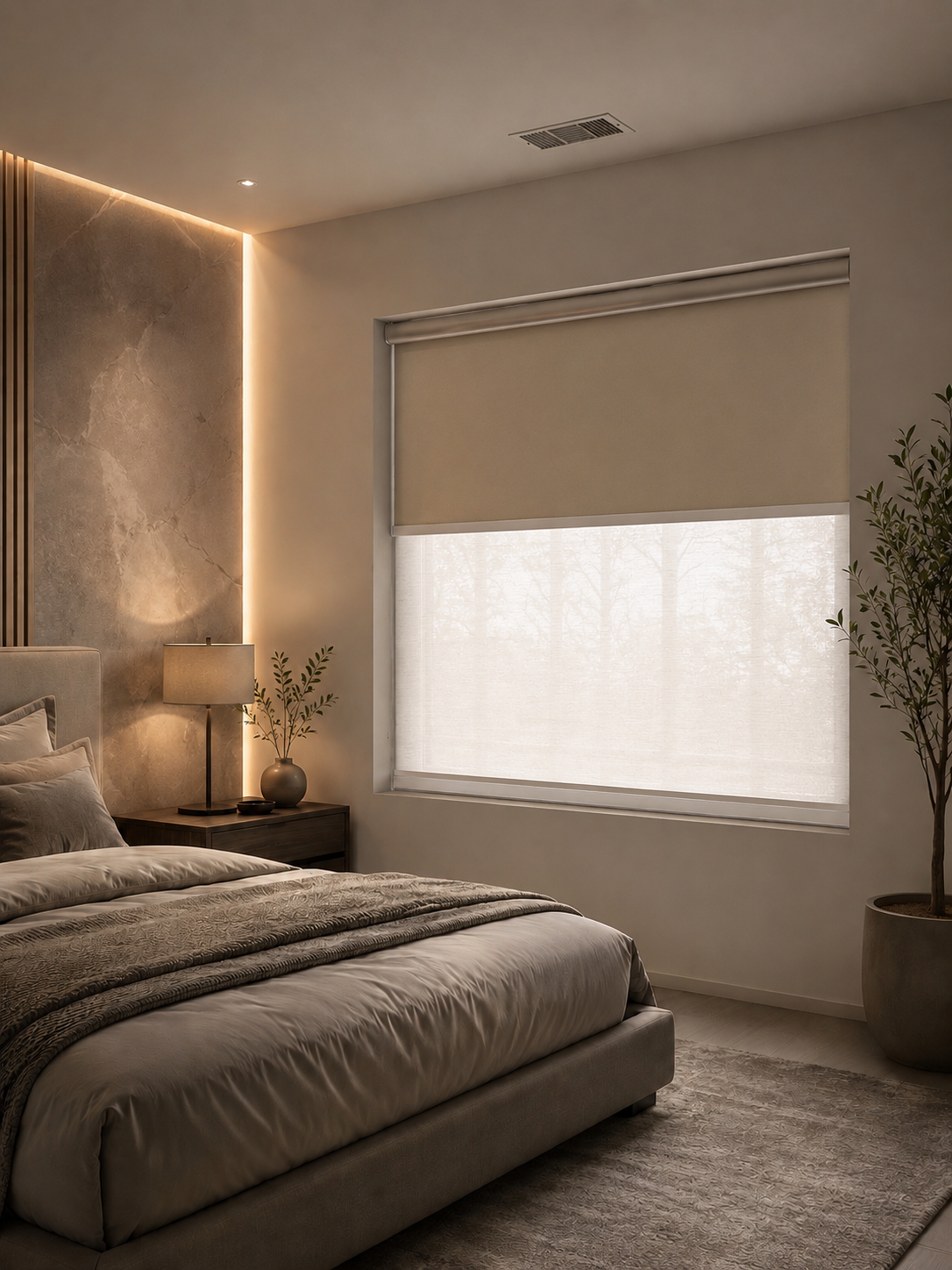Dual roller shade lowered beside a lamp in a warmly lit room