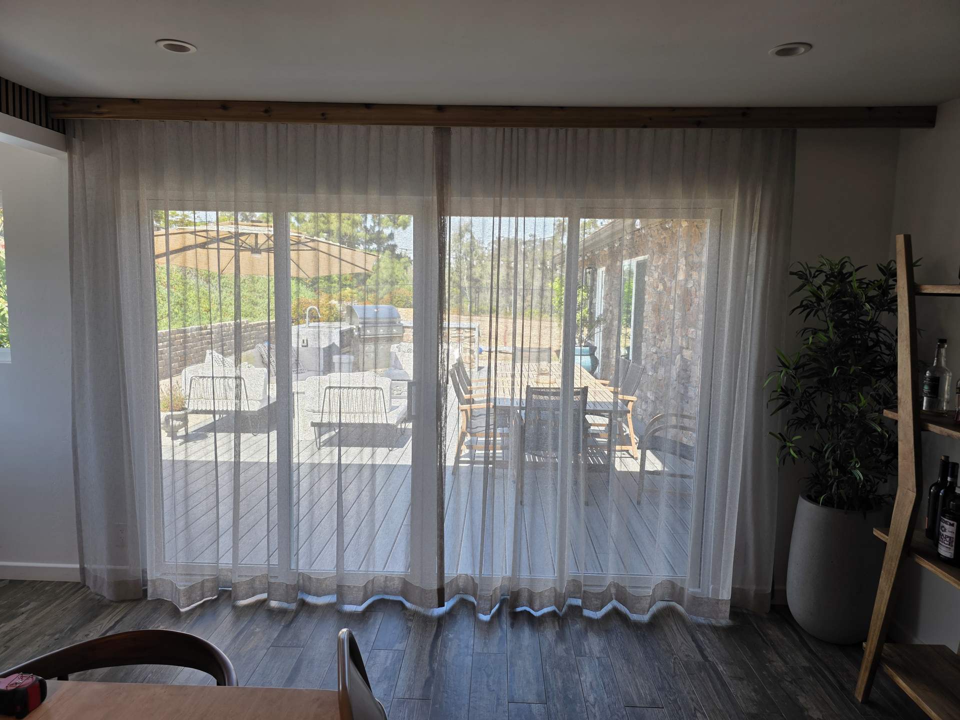Sheer custom drapery across a wide slider in a San Diego home