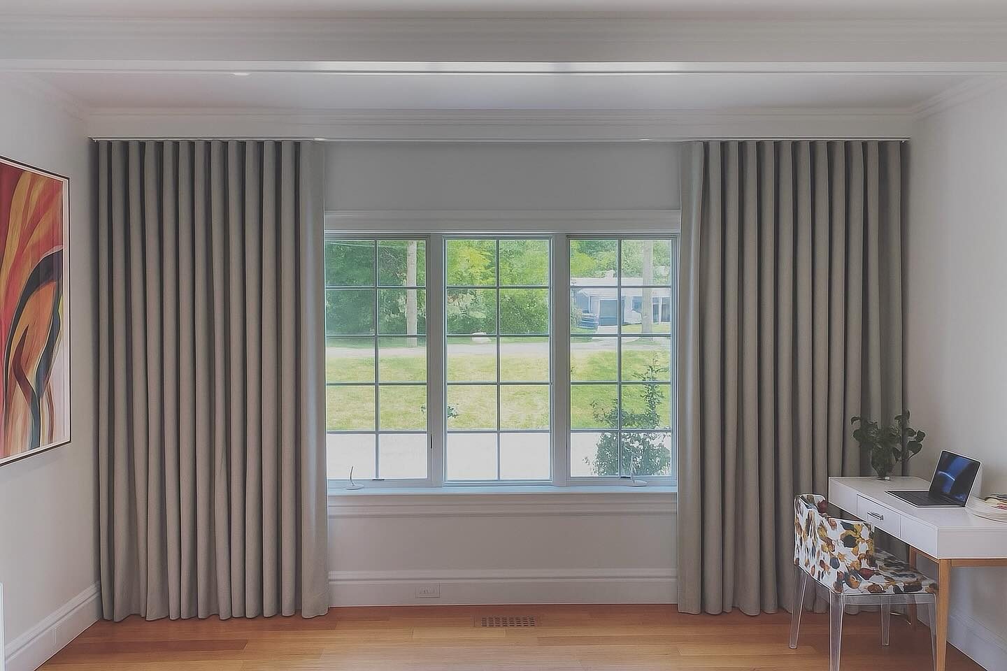 Pleated grey drapery panels framing a window in a San Diego home office