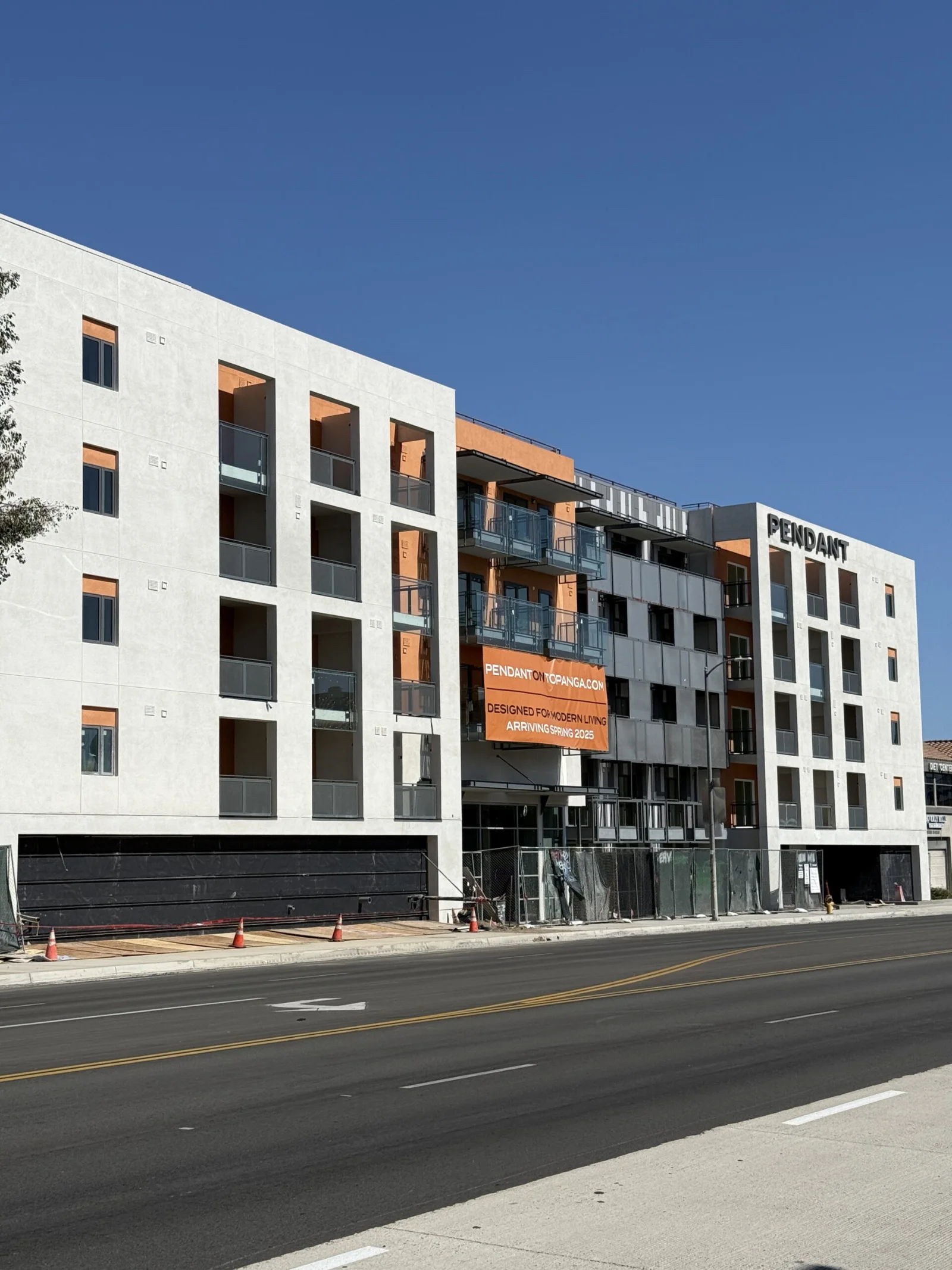 A multi-storey building under construction, seen from the street